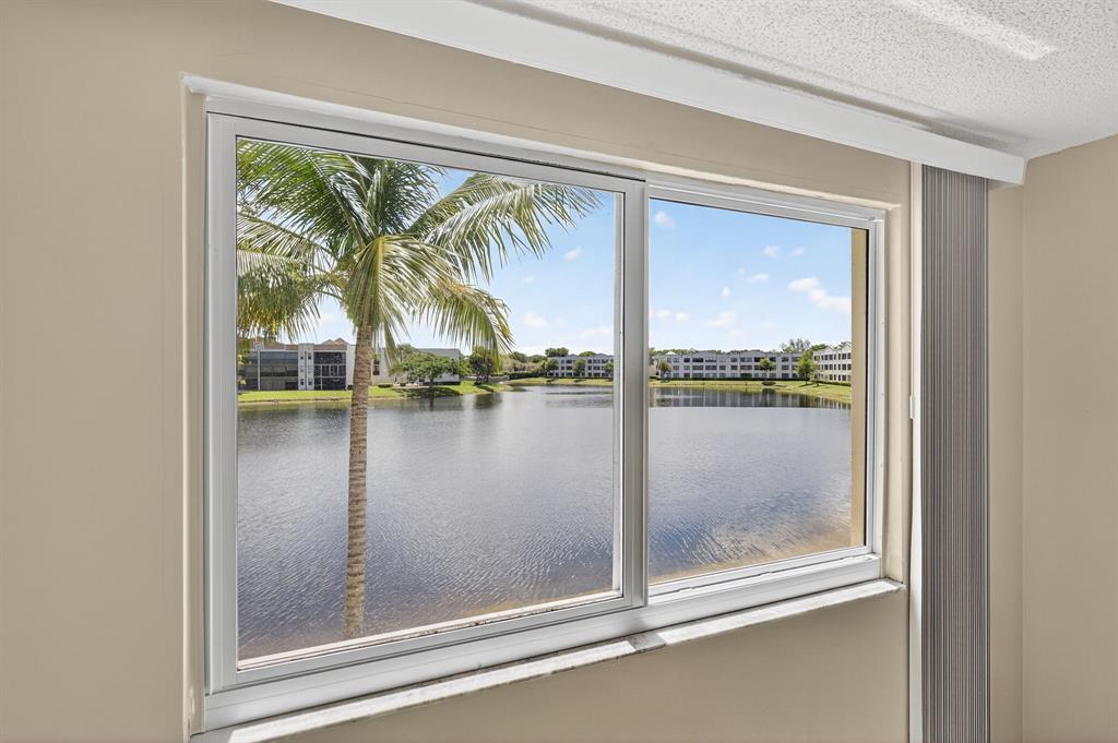 7214 South Devon Drive, Unit 7214 Tamarac, FL 33321 - Photo 13 of 24 a view of swimming pool from a window