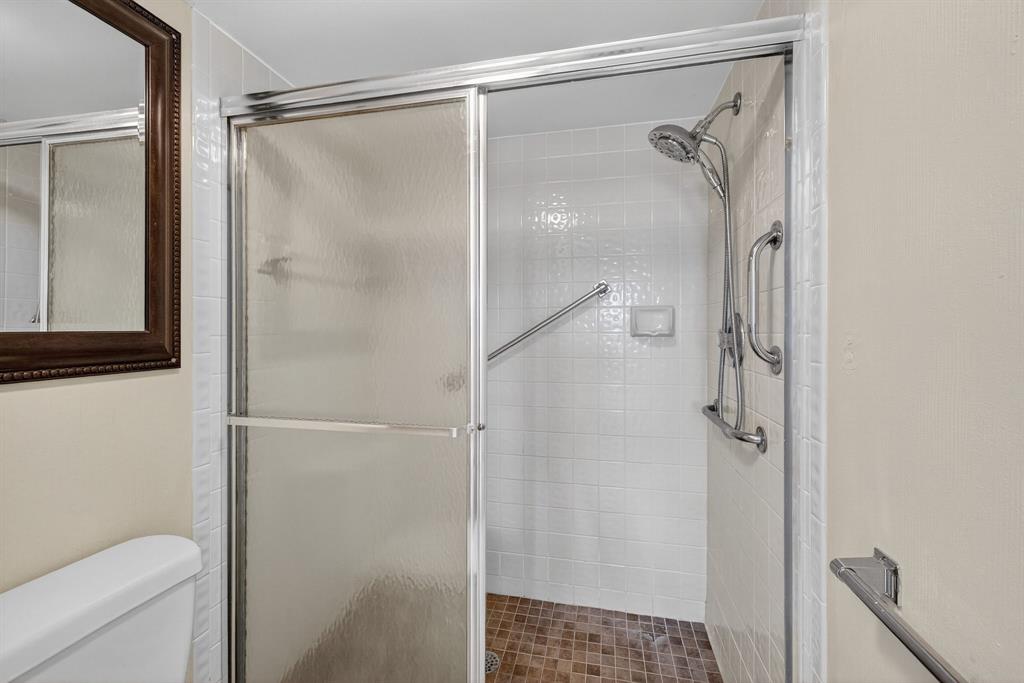 7214 South Devon Drive, Unit 7214 Tamarac, FL 33321 - Photo 16 of 24 a bathroom with a glass shower door