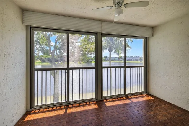 a view of a room with wooden floor and a floor to ceiling window