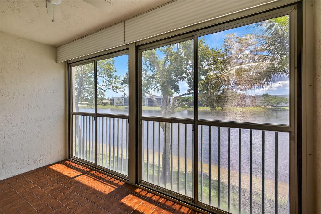 7214 South Devon Drive, Unit 7214 Tamarac, FL 33321 - Photo 19 of 24 a view of a room with wooden floor and a floor to ceiling window