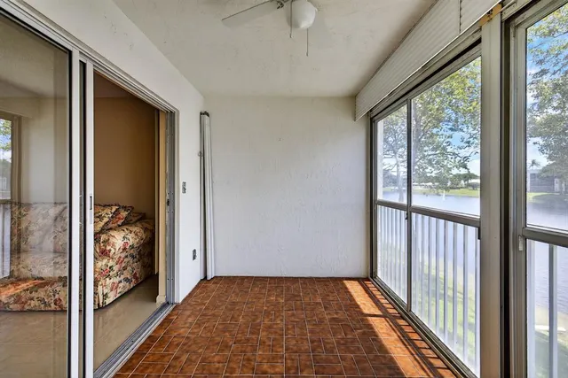 an aerial view of a swimming pool with a yard and plants