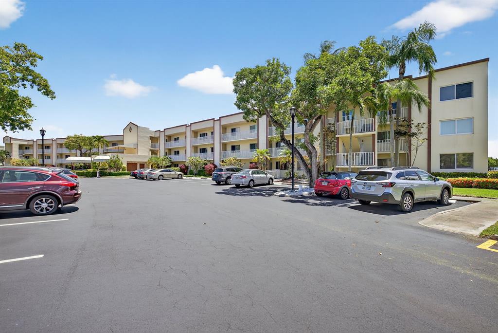 7214 South Devon Drive, Unit 7214 Tamarac, FL 33321 - Photo 2 of 24 a view of a cars park in front of a building