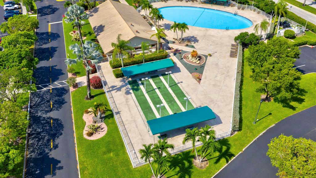 7214 South Devon Drive, Unit 7214 Tamarac, FL 33321 - Photo 21 of 24 an aerial view of a swimming pool with a yard and plants