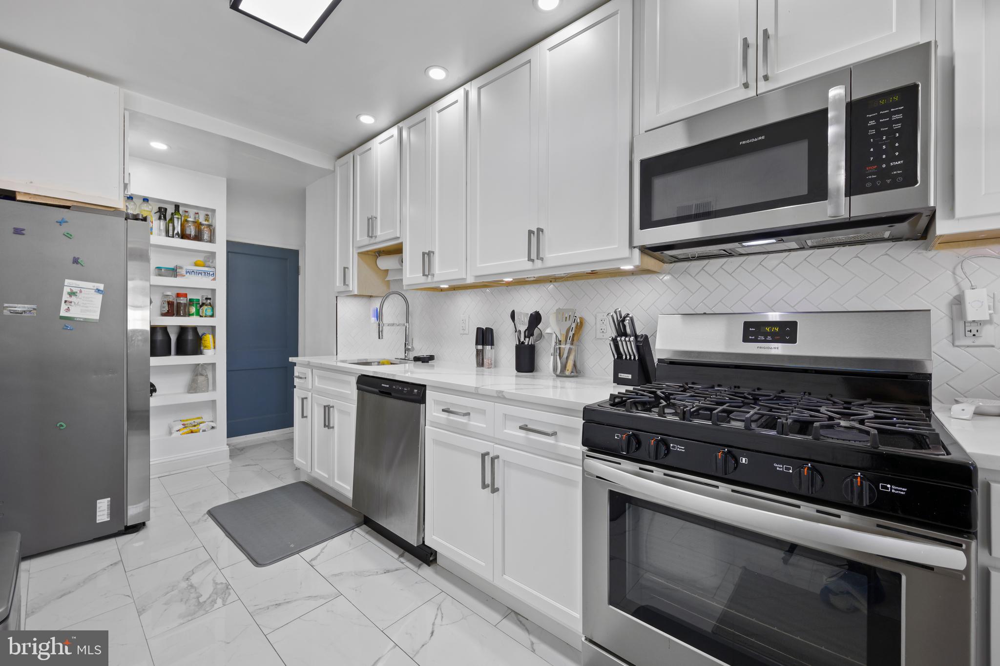 4511 Marble Hall Road Baltimore, MD 21239 - Photo 17 of 48 a kitchen with stainless steel appliances granite countertop a stove a microwave and a refrigerator