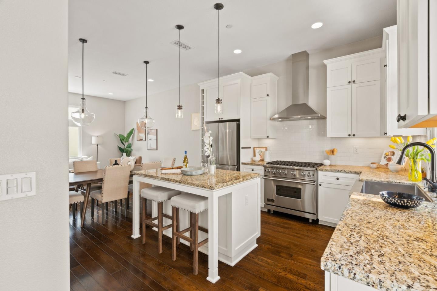 525 Fierro Loop Campbell, CA 95008 - Photo 3 of 48 a large kitchen with granite countertop a stove a sink a center island and cabinets
