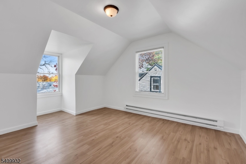 26 Center Oak Avenue Lawnside, NJ 08045 - Photo 11 of 12 an empty room with a window and wooden floor