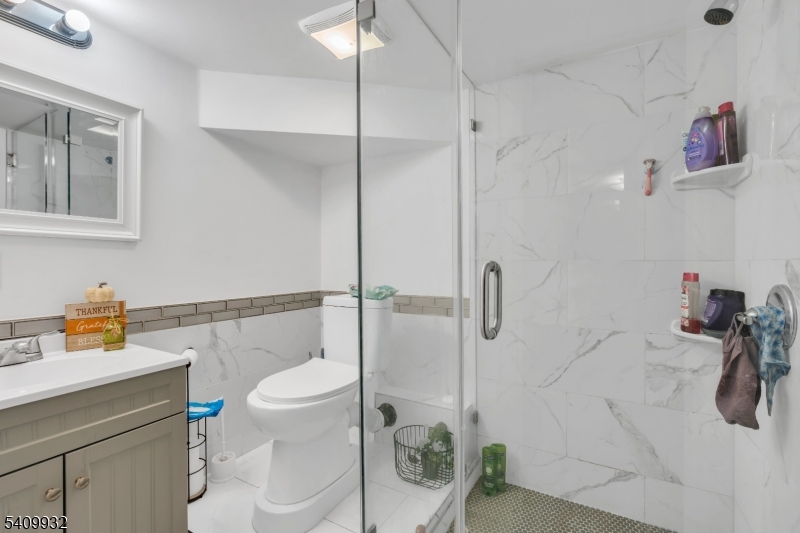 26 Center Oak Avenue Lawnside, NJ 08045 - Photo 6 of 12 a bathroom with a sink a toilet and a shower