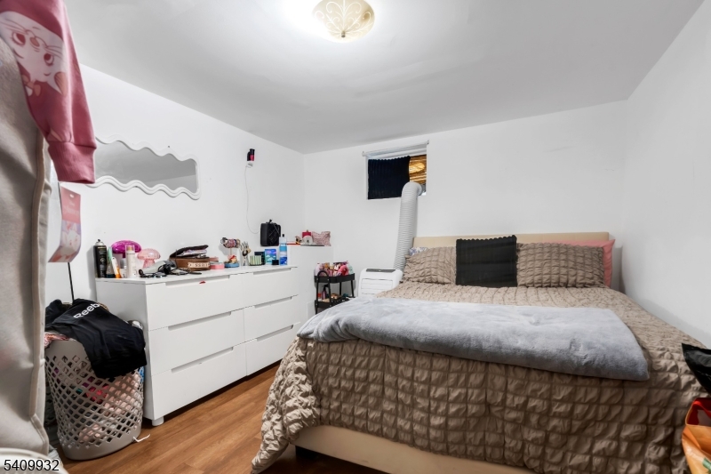 26 Center Oak Avenue Lawnside, NJ 08045 - Photo 8 of 12 a bedroom with a bed and a window