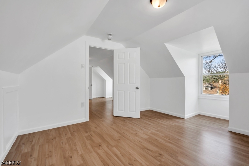26 Center Oak Avenue Lawnside, NJ 08045 - Photo 10 of 12 an empty room with wooden floor and windows