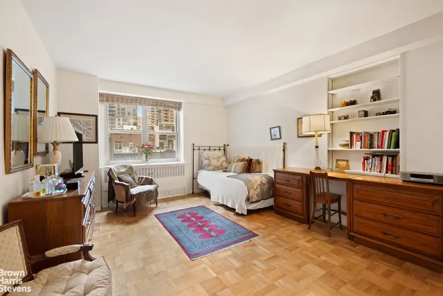 a bedroom with furniture and a book shelf