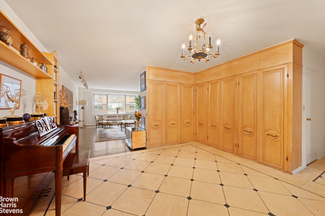 135 East 83rd Street, Unit 7A Manhattan, NY 10028 - Photo 7 of 8 a view of a livingroom with furniture and chandelier