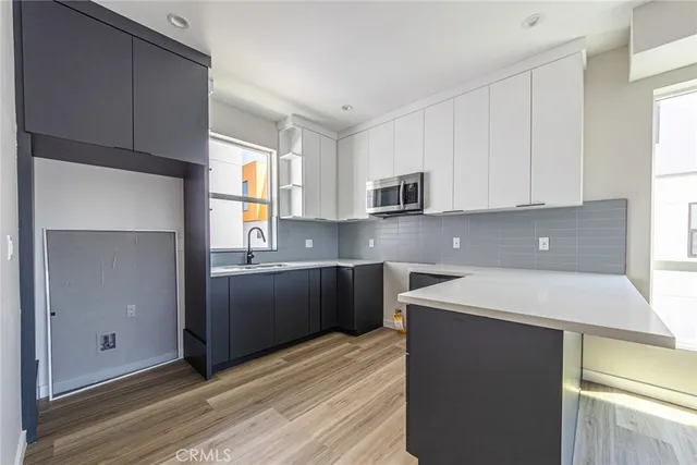 a kitchen with kitchen island granite countertop a sink stainless steel appliances and cabinets