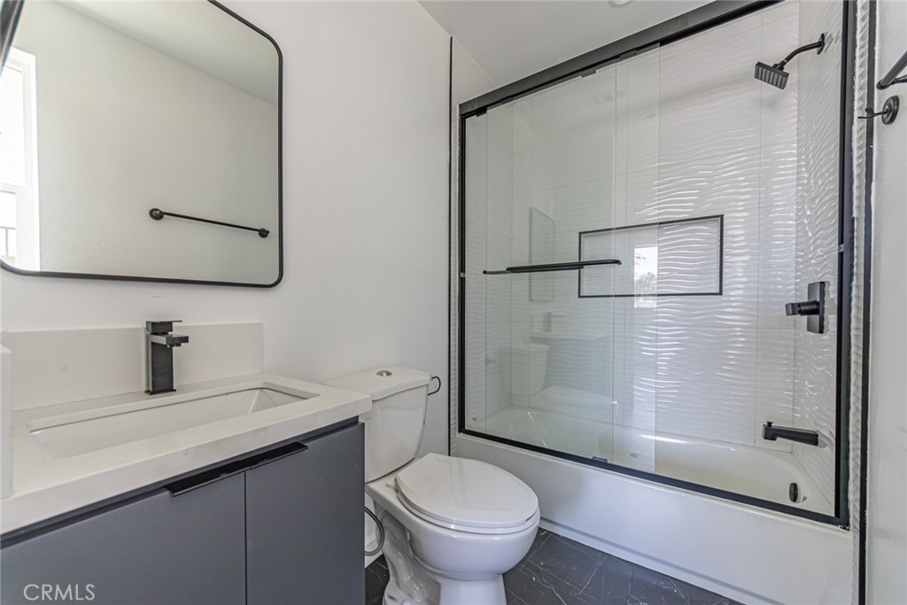 6700 Balboa Boulevard, Unit 1 Van Nuys, CA 91406 - Photo 20 of 54 a bathroom with a granite countertop sink toilet and shower