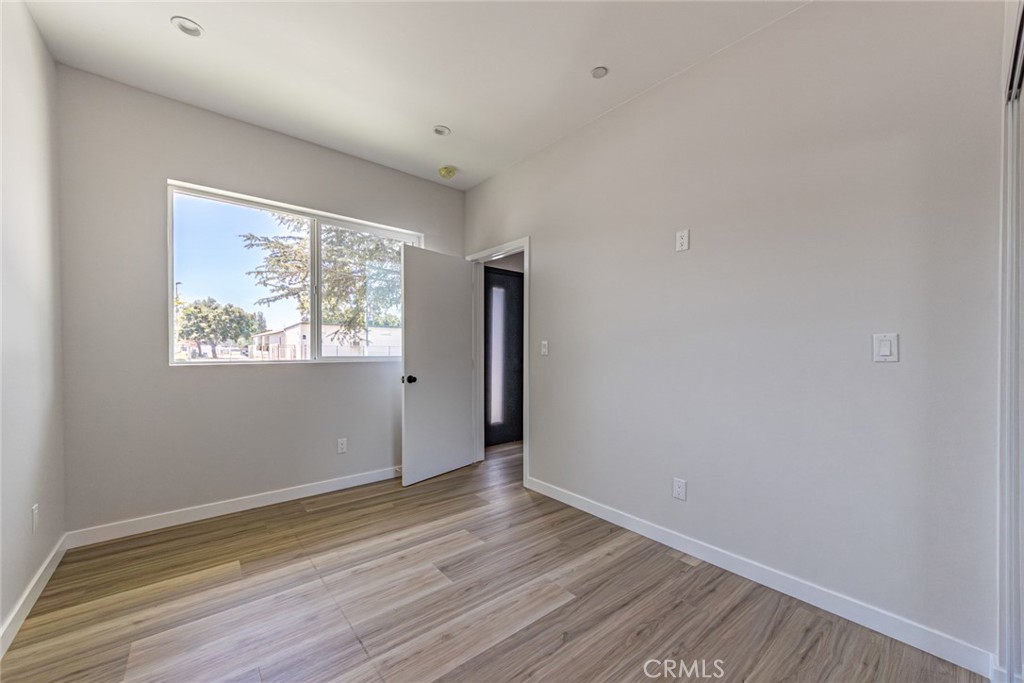 6700 Balboa Boulevard, Unit 1 Van Nuys, CA 91406 - Photo 22 of 54 an empty room with wooden floor and windows