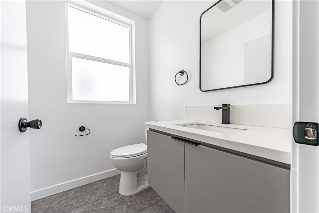 6700 Balboa Boulevard, Unit 1 Van Nuys, CA 91406 - Photo 23 of 54 a bathroom with a toilet sink and mirror