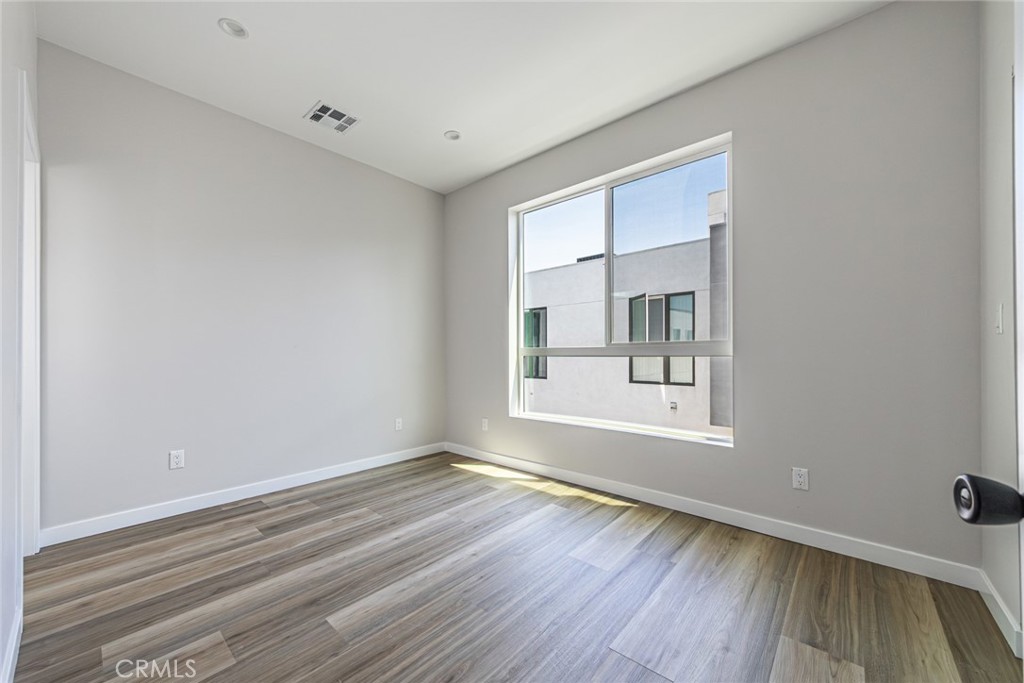 6700 Balboa Boulevard, Unit 1 Van Nuys, CA 91406 - Photo 24 of 54 a view of an empty room with wooden floor and a window