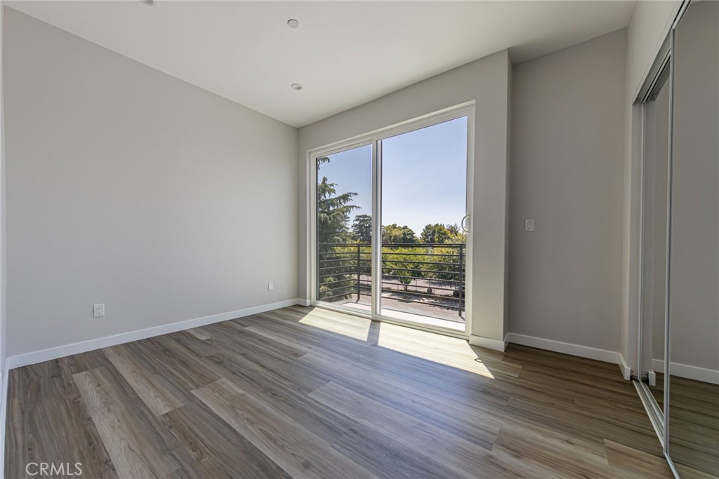 6700 Balboa Boulevard, Unit 1 Van Nuys, CA 91406 - Photo 29 of 54 an empty room with wooden floor and windows