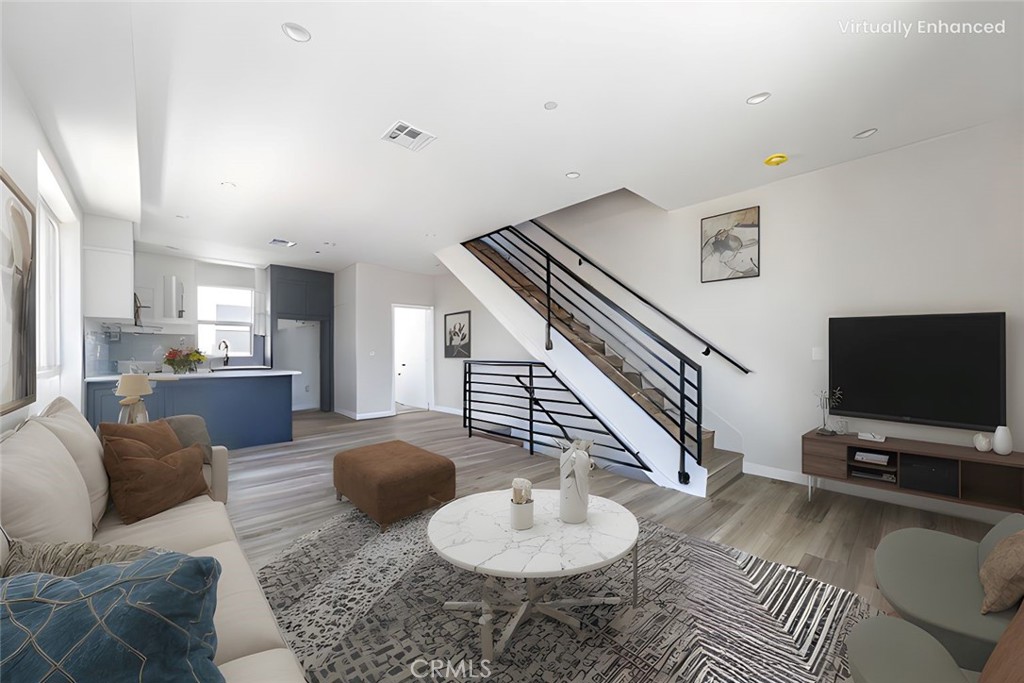 6700 Balboa Boulevard, Unit 1 Van Nuys, CA 91406 - Photo 3 of 54 a living room with furniture and a flat screen tv