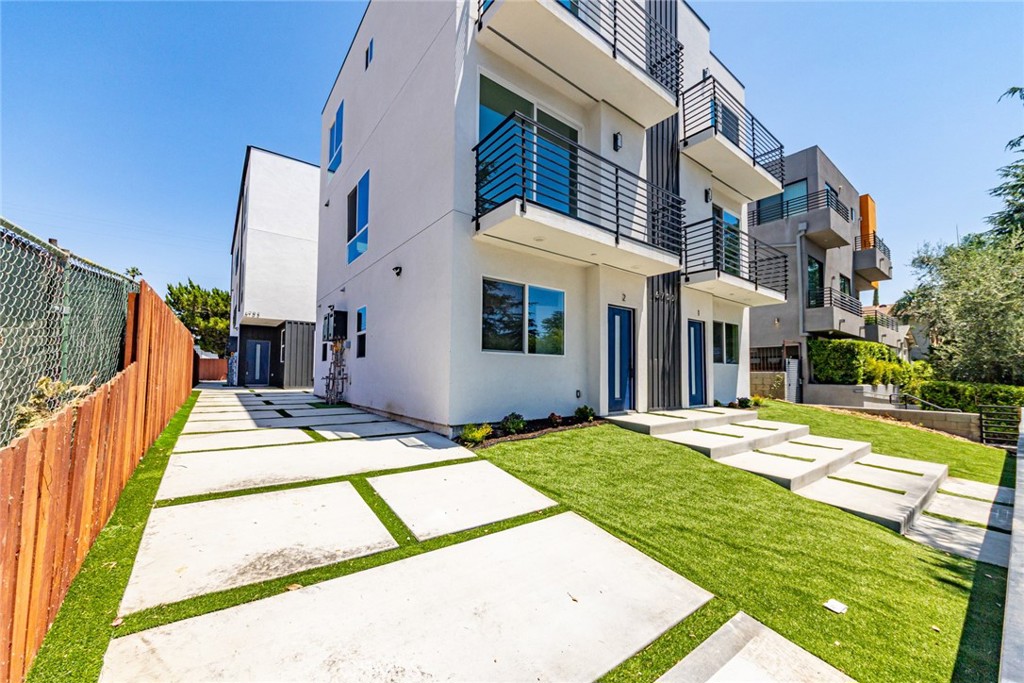 6700 Balboa Boulevard, Unit 1 Van Nuys, CA 91406 - Photo 36 of 54 a view of a white house with a yard and table and chairs next to a yard
