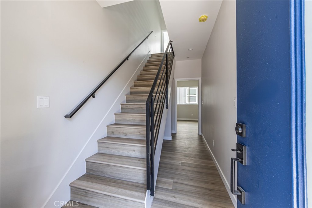 6700 Balboa Boulevard, Unit 1 Van Nuys, CA 91406 - Photo 9 of 54 a view of staircase with wooden floor and white walls