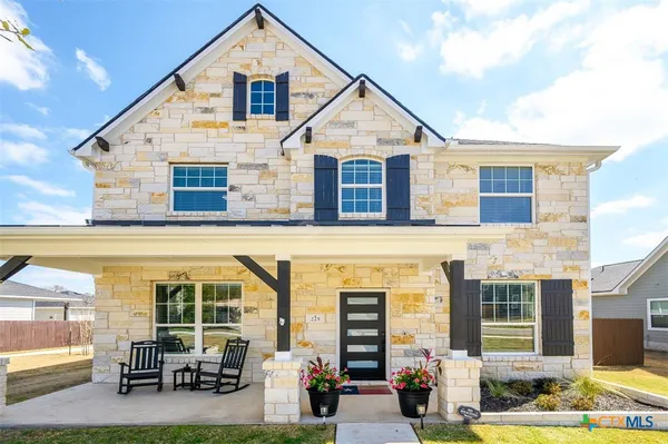 a front view of house with outdoor seating