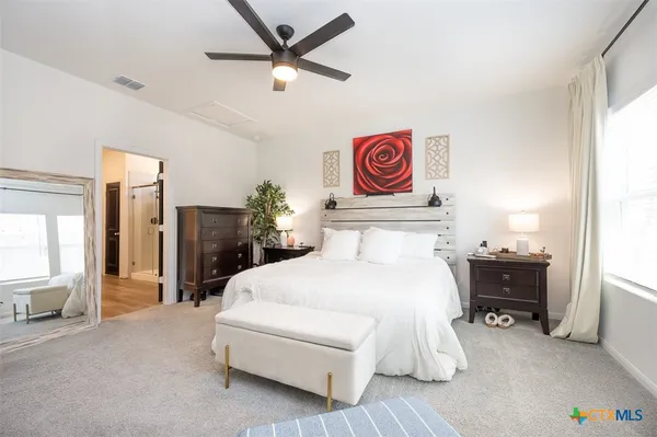 a bedroom with a bed and a chandelier