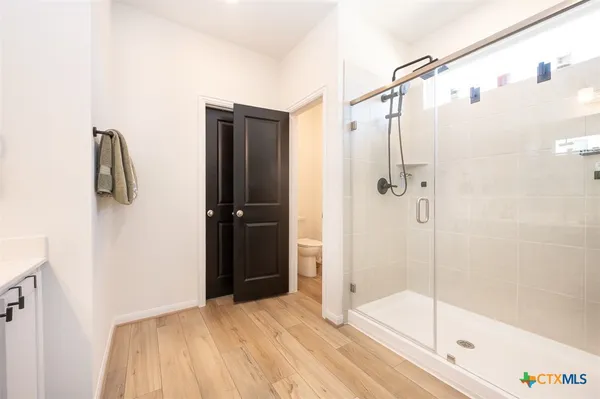 a bathroom with a shower and a glass door