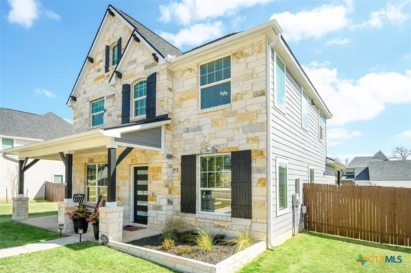 a view of a house with backyard porch and sitting area