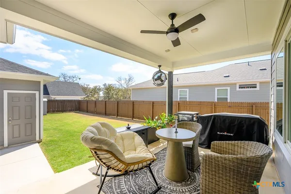 a dining room with furniture and a floor to ceiling window