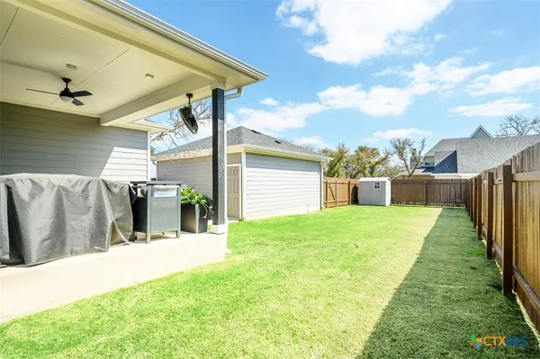 a view of a backyard with sitting area