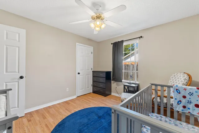 a bedroom with furniture and a baby crib