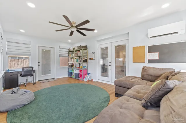 a bedroom with furniture and a wooden floor