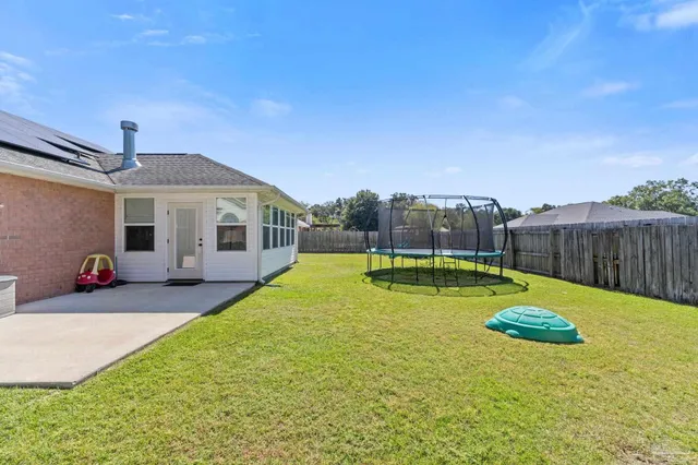 a view of a house with swimming pool and a yard
