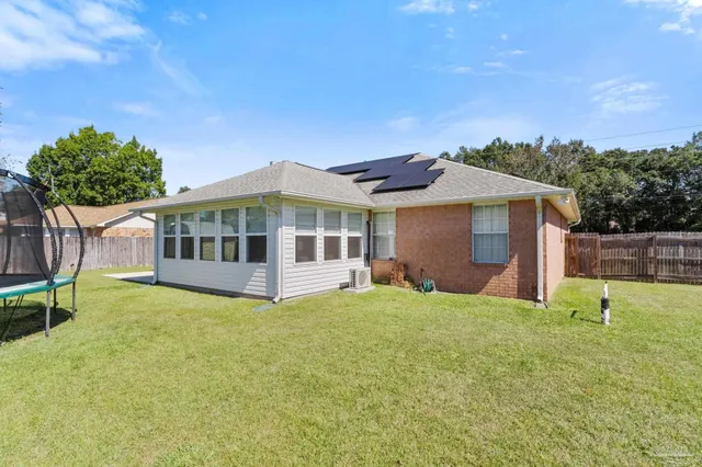 a view of a house with a yard and sitting area