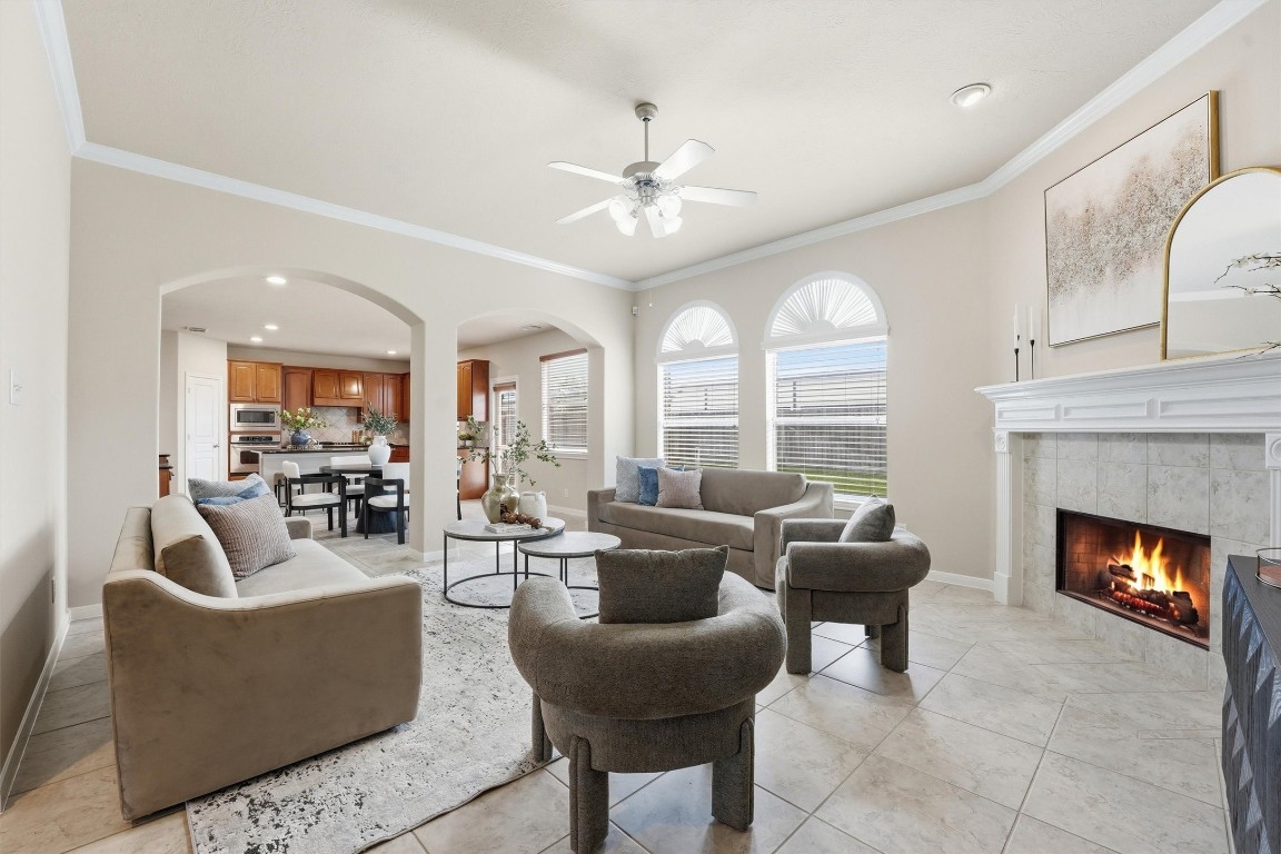 17415 Memorial Mills Drive Spring, TX 77379 - Photo 11 of 37 a living room with furniture a fireplace and a large window