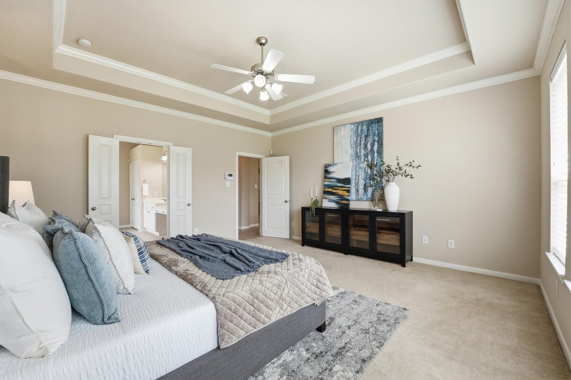 17415 Memorial Mills Drive Spring, TX 77379 - Photo 15 of 37 a bedroom with a bed and a chandelier
