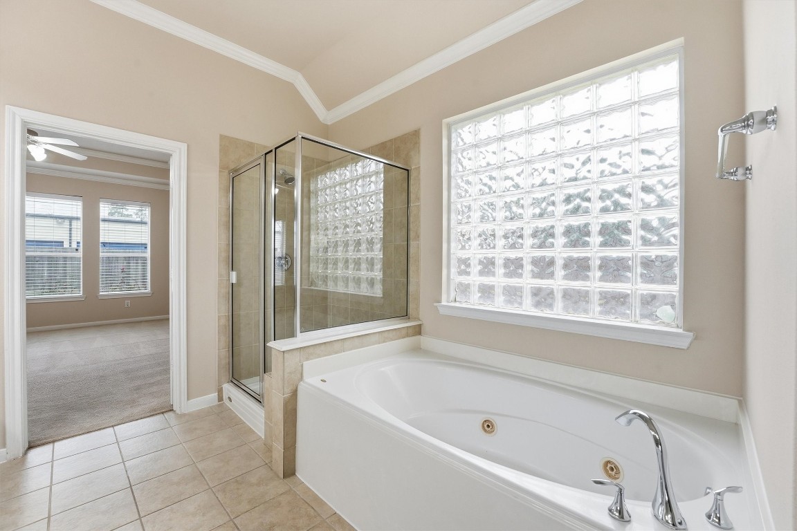 17415 Memorial Mills Drive Spring, TX 77379 - Photo 17 of 37 a bathroom with a bathtub and a shower