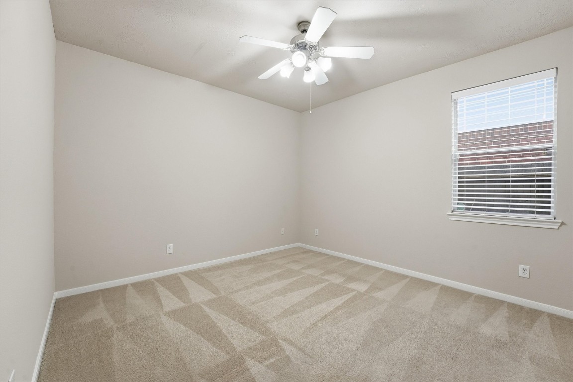 17415 Memorial Mills Drive Spring, TX 77379 - Photo 19 of 37 an empty room with windows and fan