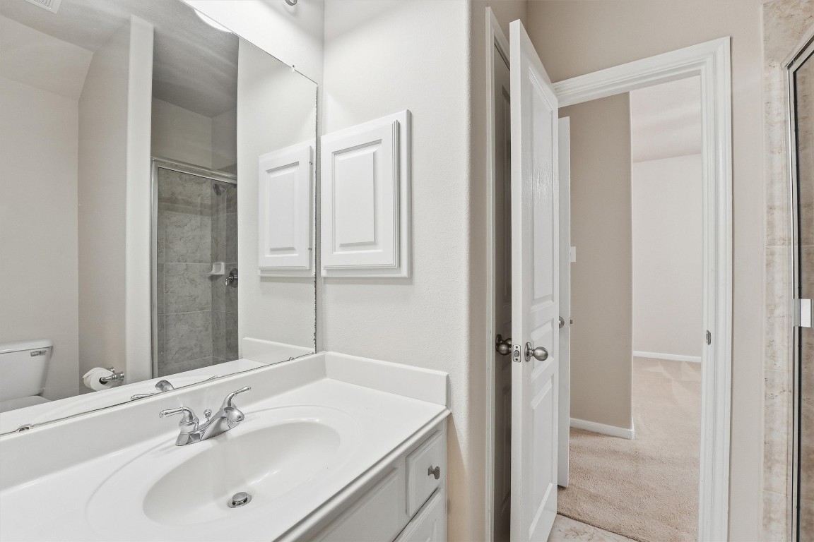 17415 Memorial Mills Drive Spring, TX 77379 - Photo 20 of 37 a bathroom with a sink and a mirror