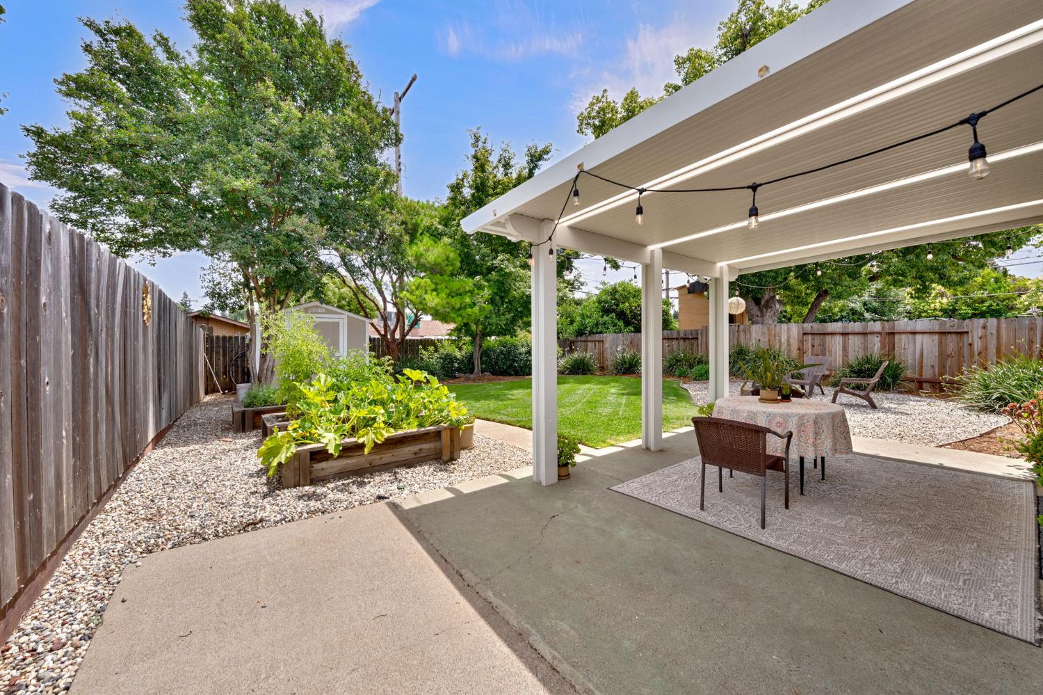 5422 Earnell Street Carmichael, CA 95608 - Photo 33 of 39 a view of a patio with table and chairs potted plants with wooden fence