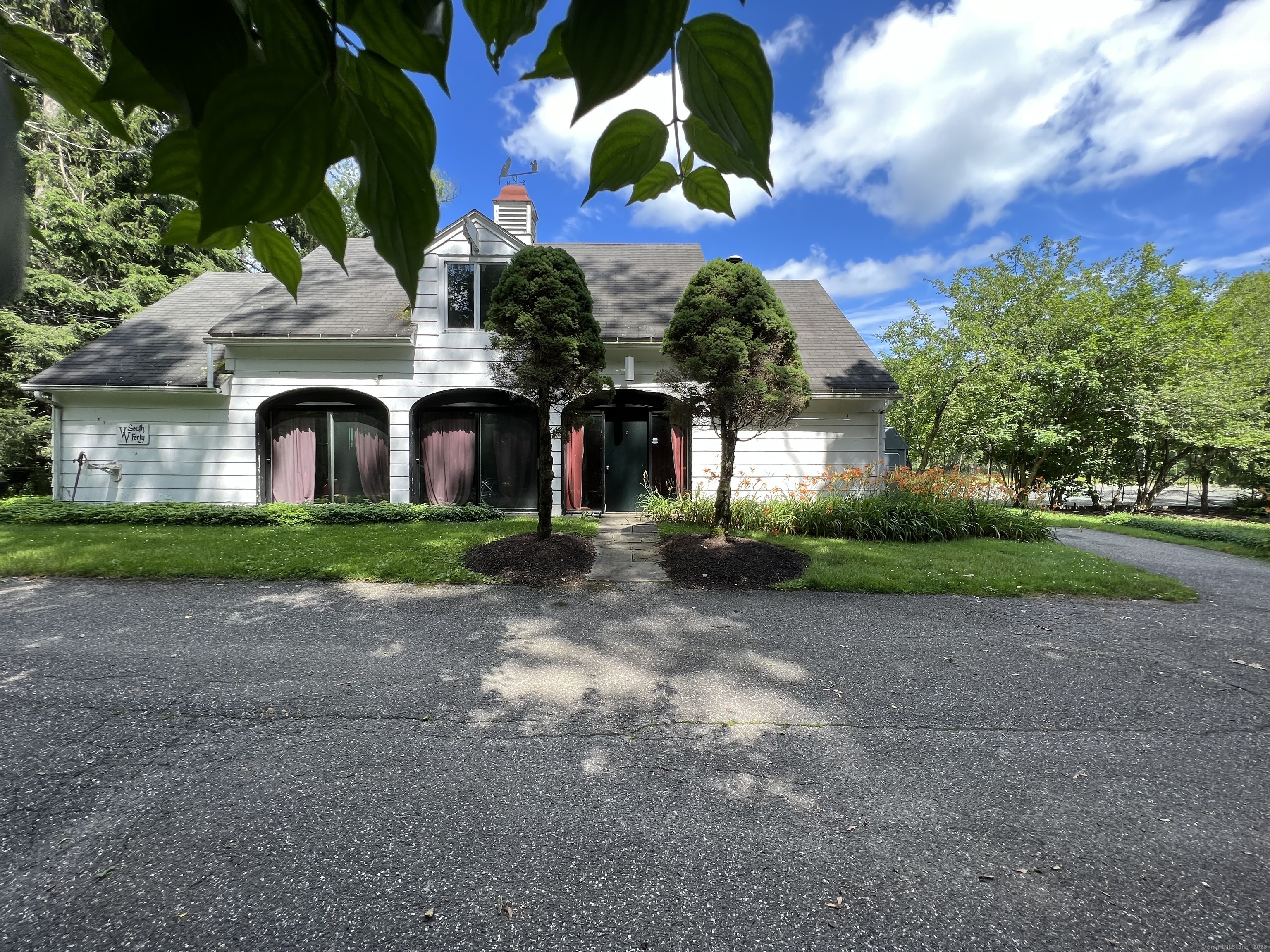 a front view of a house with garden