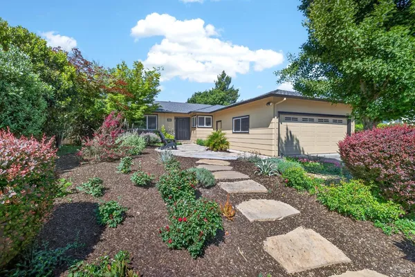 a front view of a house with garden