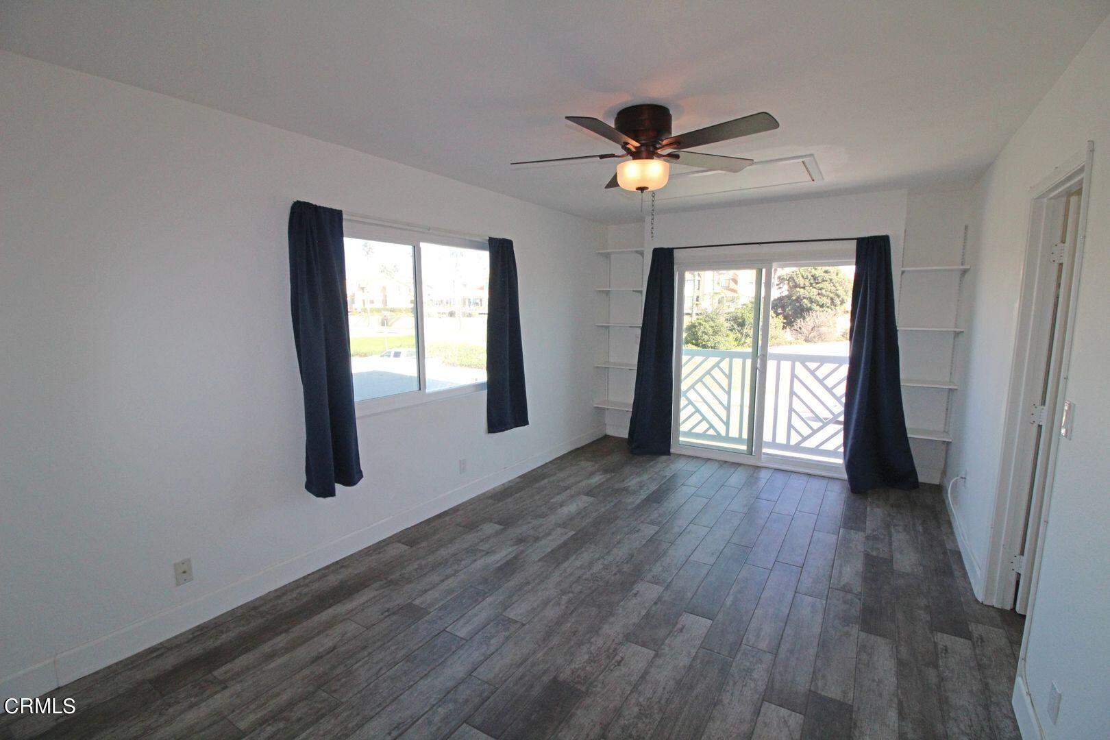 4185 Sunset Lane Oxnard, CA 93035 - Photo 12 of 32 a view of an empty room with wooden floor and a window