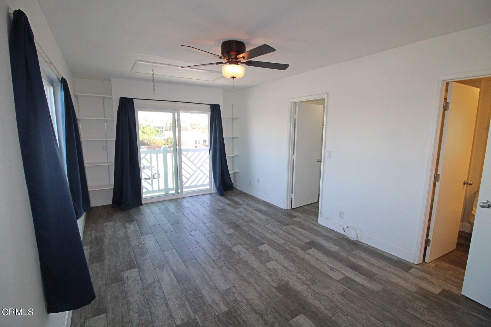 4185 Sunset Lane Oxnard, CA 93035 - Photo 13 of 32 an empty room with wooden floor and windows