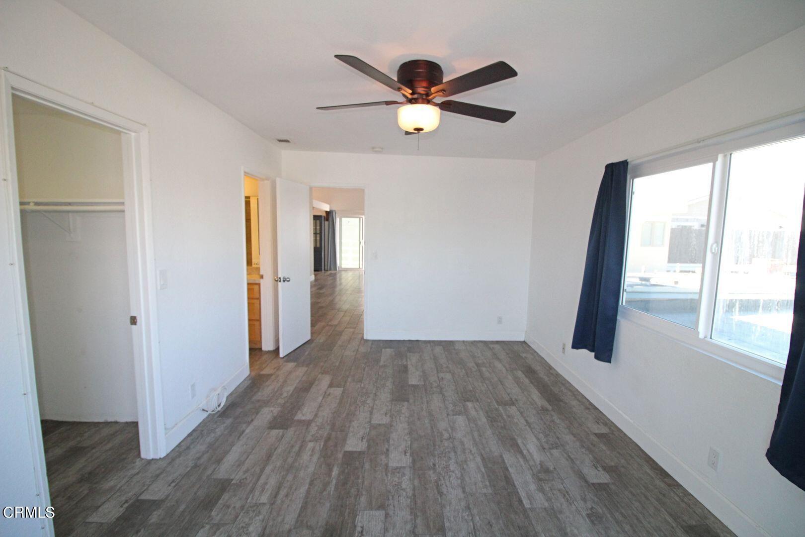 4185 Sunset Lane Oxnard, CA 93035 - Photo 17 of 32 a view of empty room with wooden floor and fan