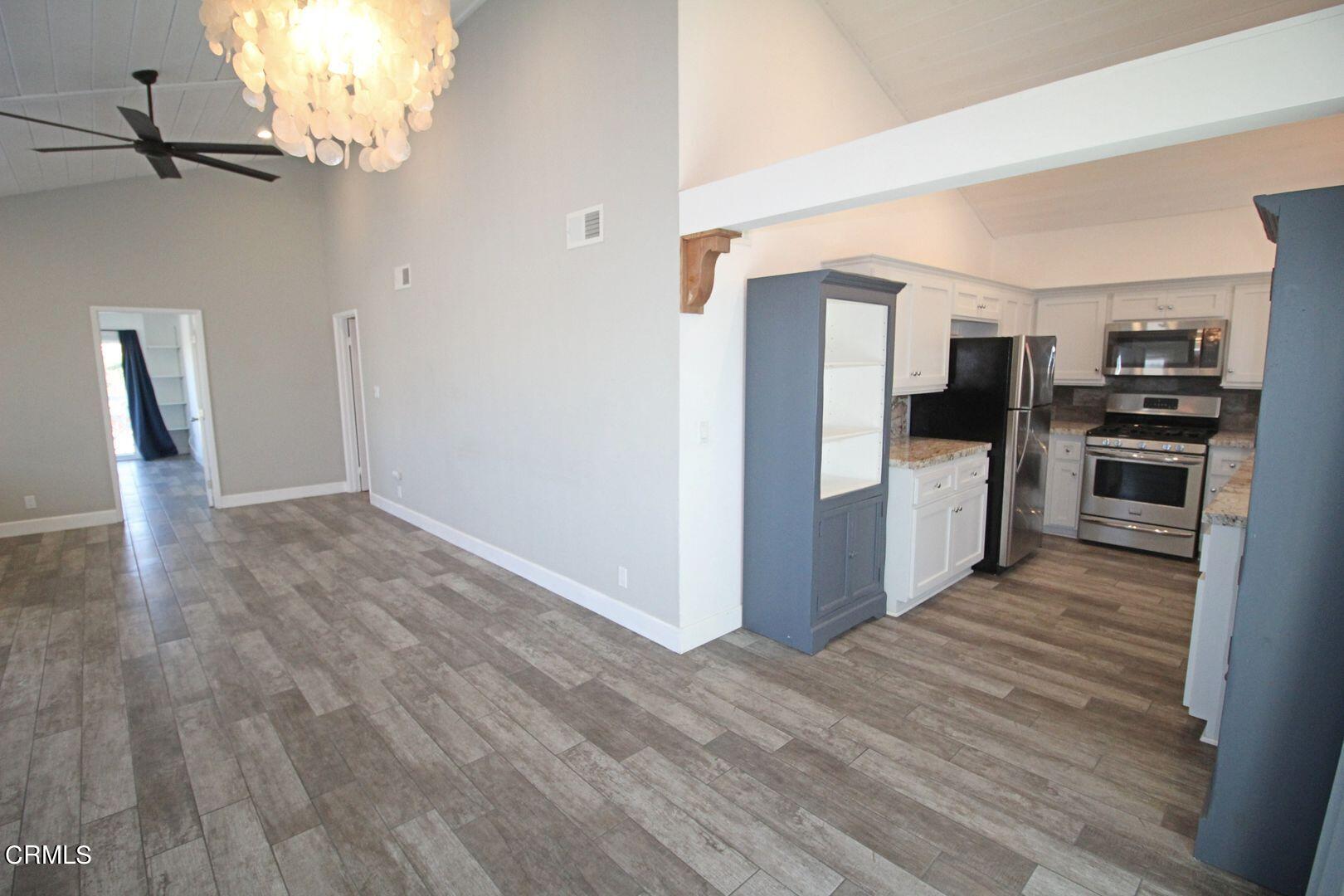 4185 Sunset Lane Oxnard, CA 93035 - Photo 4 of 32 a view of a kitchen with wooden floor electronic appliances and wooden floor