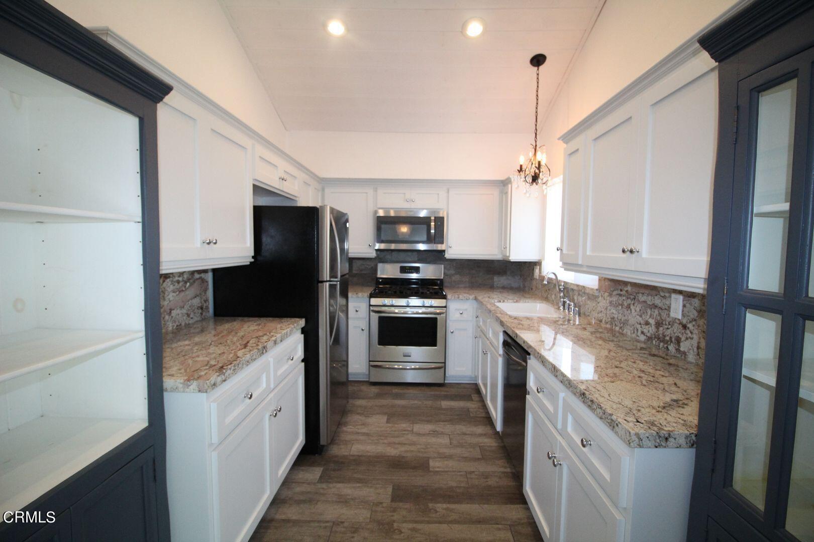 4185 Sunset Lane Oxnard, CA 93035 - Photo 5 of 32 a kitchen with stainless steel appliances granite countertop a stove and a refrigerator