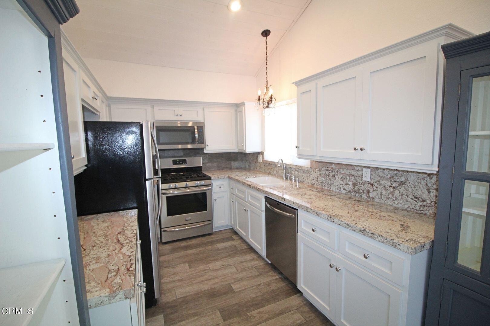 4185 Sunset Lane Oxnard, CA 93035 - Photo 6 of 32 a kitchen with a sink stove and refrigerator