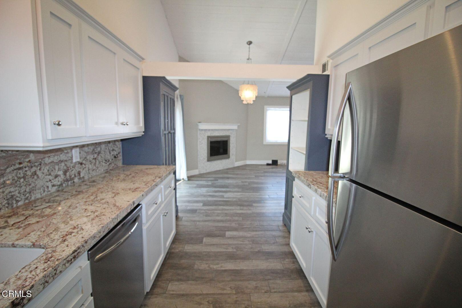4185 Sunset Lane Oxnard, CA 93035 - Photo 7 of 32 a kitchen with granite countertop a refrigerator and a sink