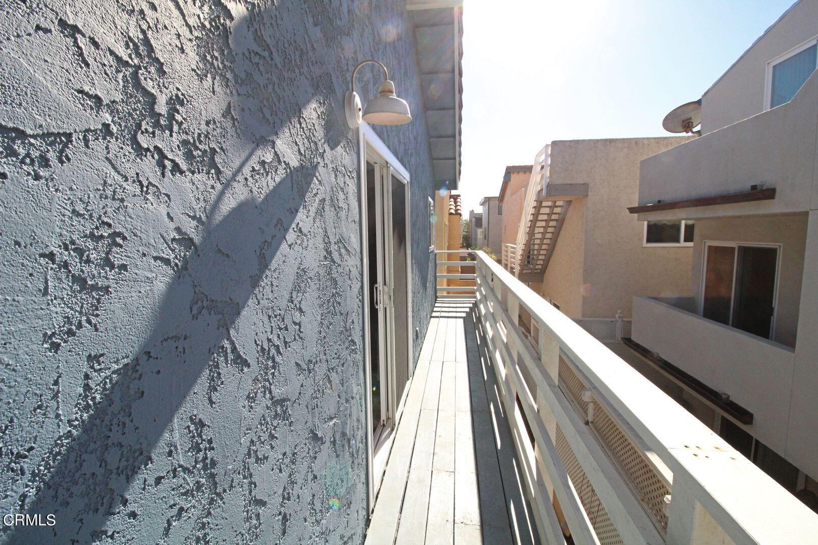 4185 Sunset Lane Oxnard, CA 93035 - Photo 10 of 32 a view of balcony with wooden floor and fence